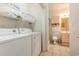 Laundry area with a washer and dryer, next to an ensuite bathroom at 4812 Magnolia Lake Dr. # 102, Myrtle Beach, SC 29577