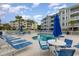 Pool surrounded by white fence with blue umbrellas and lounge chairs at 4812 Magnolia Lake Dr. # 102, Myrtle Beach, SC 29577