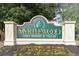 Entrance sign for Myrtlewood Golf Resort and Villas with colorful flowers at 4812 Magnolia Lake Dr. # 102, Myrtle Beach, SC 29577