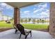 Patio view of lawn, pond, and other condo buildings in the distance at 4812 Magnolia Lake Dr. # 102, Myrtle Beach, SC 29577