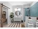 Bathroom features a round mirror, vessel sink, shiplap and blue tile shower at 4832 Williams Island Dr., Little River, SC 29566