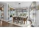 Bright dining area with a modern table, stylish chairs, and large windows that offer beautiful views of the waterfront at 4832 Williams Island Dr., Little River, SC 29566