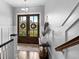 Inviting foyer featuring a charming table and clear view of the home's manicured front yard through double doors at 4832 Williams Island Dr., Little River, SC 29566