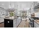 Open-concept kitchen featuring a large island with seating, modern appliances, and a view of the dining area and living room at 4832 Williams Island Dr., Little River, SC 29566