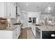Modern kitchen showcasing white cabinets, a large island with seating, stainless steel appliances, and granite countertops at 4832 Williams Island Dr., Little River, SC 29566