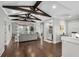 Open-concept living room with hardwood floors, beamed ceilings, and a cozy seating area at 4832 Williams Island Dr., Little River, SC 29566