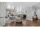 Open-concept living room with modern furniture and hardwood floors that seamlessly connects to the kitchen and dining area at 4832 Williams Island Dr., Little River, SC 29566