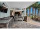 Well-equipped outdoor kitchen with stone accents, stainless steel appliances, and convenient access to the dining area at 4832 Williams Island Dr., Little River, SC 29566
