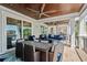 Covered patio with ceiling fans, outdoor dining table, and lounge seating overlooking the water at 4832 Williams Island Dr., Little River, SC 29566