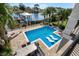 Backyard featuring a pool with sunbeds, waterfront views, and outdoor dining area at 4832 Williams Island Dr., Little River, SC 29566