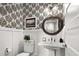 Elegant powder room with decorative wallpaper, pedestal sink, and charming details at 4832 Williams Island Dr., Little River, SC 29566