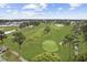 Scenic aerial view of golf course, green, trees, and nearby community at 4879 Dahlia Ct. # 302, Myrtle Beach, SC 29577