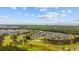 Stunning aerial view showcasing the golf course, community, lake, and meticulously maintained landscaping at 4879 Dahlia Ct. # 302, Myrtle Beach, SC 29577