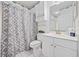 Cozy bathroom with a decorative shower curtain, white cabinetry, and a well-lit vanity area at 4879 Dahlia Ct. # 302, Myrtle Beach, SC 29577