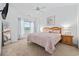 Relaxing bedroom with soft carpet, light-colored walls, a cozy queen-sized bed, and a large window at 4879 Dahlia Ct. # 302, Myrtle Beach, SC 29577