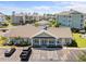 Exterior view of the community clubhouse with ample parking and well-maintained landscaping at 4879 Dahlia Ct. # 302, Myrtle Beach, SC 29577