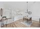 Bright dining area with a modern chandelier, table seating for four, and hardwood flooring at 4879 Dahlia Ct. # 302, Myrtle Beach, SC 29577