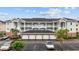 Beautiful condo exterior with garage parking, white railings and a well manicured landscape at 4879 Dahlia Ct. # 302, Myrtle Beach, SC 29577
