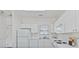 All-white kitchen features modern appliances and plentiful counter space, perfect for any home chef at 4879 Dahlia Ct. # 302, Myrtle Beach, SC 29577