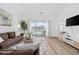 Comfortable living room with a plush sofa, stylish decor, and sliding doors to the balcony at 4879 Dahlia Ct. # 302, Myrtle Beach, SC 29577