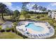 Community pool with ample lounge chairs and mature trees, near golf course and clubhouse at 4879 Dahlia Ct. # 302, Myrtle Beach, SC 29577