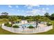 Beautiful community pool and lounge area surrounded by lush landscaping and white picket fence at 4879 Dahlia Ct. # 302, Myrtle Beach, SC 29577