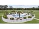 Aerial view of a community pool surrounded by lounge chairs, palm trees, and lush landscaping at 4879 Dahlia Ct. # 302, Myrtle Beach, SC 29577