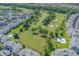 Aerial view showcasing the community’s condos adjacent to a well-manicured golf course with mature trees at 4895 Luster Leaf Circle # 304, Myrtle Beach, SC 29577