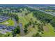 Wide aerial view showcases the community's lush golf course with ponds and surrounding mature trees and condos at 4895 Luster Leaf Circle # 304, Myrtle Beach, SC 29577