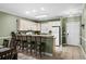 Open kitchen with bar seating, stainless appliances, and tile flooring offers a modern, eat-in space at 4895 Luster Leaf Circle # 304, Myrtle Beach, SC 29577