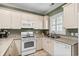 Cozy kitchen featuring stainless steel appliances, lots of storage, and a bright window at 4895 Luster Leaf Circle # 304, Myrtle Beach, SC 29577