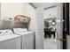 Laundry room adjacent to dining room, featuring modern washer and dryer at 4895 Luster Leaf Circle # 304, Myrtle Beach, SC 29577