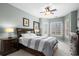 Serene main bedroom with tray ceiling, ceiling fan, and natural light from shuttered windows at 4895 Luster Leaf Circle # 304, Myrtle Beach, SC 29577