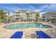 Resort-style pool area with lounge chairs and lush landscaping at 4895 Luster Leaf Circle # 304, Myrtle Beach, SC 29577