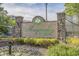 Welcome to Magnolia Pointe! Beautiful entrance sign with brick pillars surrounded by lush greenery and colorful flowers at 4895 Luster Leaf Circle # 304, Myrtle Beach, SC 29577