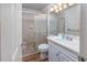 Full bathroom features shower, toilet, vanity, and mirror; all are modern and well lit at 5001 N Ocean Blvd. # 1F, North Myrtle Beach, SC 29582