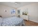 Bright bedroom showcases wood floors, a dresser with a TV, and a view of the outdoors at 5001 N Ocean Blvd. # 1F, North Myrtle Beach, SC 29582