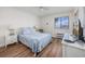 Cozy bedroom featuring wood floors, a window view, a TV, and beachy decor at 5001 N Ocean Blvd. # 1F, North Myrtle Beach, SC 29582