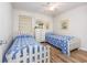 Bright bedroom showcasing two twin beds, matching decor, and wood-look flooring at 5001 N Ocean Blvd. # 1F, North Myrtle Beach, SC 29582