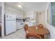 Functional kitchen and dining area, equipped with modern appliances and a ceiling fan for comfort at 5001 N Ocean Blvd. # 1F, North Myrtle Beach, SC 29582