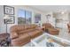 Comfortable living room with tile flooring, a plush sofa, and a bright window view of the outside at 5001 N Ocean Blvd. # 1F, North Myrtle Beach, SC 29582