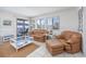 Cozy living room featuring comfortable seating, tile floors, and a view of the exterior balcony at 5001 N Ocean Blvd. # 1F, North Myrtle Beach, SC 29582
