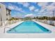 Outdoor pool with clear blue water, surrounded by a white fence and lush landscaping at 5001 N Ocean Blvd. # 1F, North Myrtle Beach, SC 29582