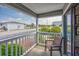 Cozy porch offers seating and views of the neighborhood, greenery, and street at 5001 N Ocean Blvd. # 1F, North Myrtle Beach, SC 29582