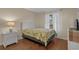 Well-lit bedroom with a comfortable bed, side table, and a view of the outdoors at 501 Maison Dr. # G-7, Myrtle Beach, SC 29572