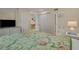 Comfortable bedroom featuring a floral comforter, closet, and access to the bathroom and other rooms at 501 Maison Dr. # G-7, Myrtle Beach, SC 29572