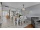 Charming dining area with white chairs and a view into the kitchen at 501 Maison Dr. # G-7, Myrtle Beach, SC 29572