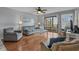 Cozy living room with hardwood floors, comfortable seating, and a sliding glass door to the balcony at 501 Maison Dr. # G-7, Myrtle Beach, SC 29572