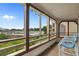 Cozy screened porch with outdoor seating, perfect for enjoying serene water views at 501 Maison Dr. # G-7, Myrtle Beach, SC 29572
