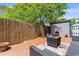 Private fenced backyard featuring a deck area with seating and mature trees at 507-C 2Nd Ave. N, North Myrtle Beach, SC 29582